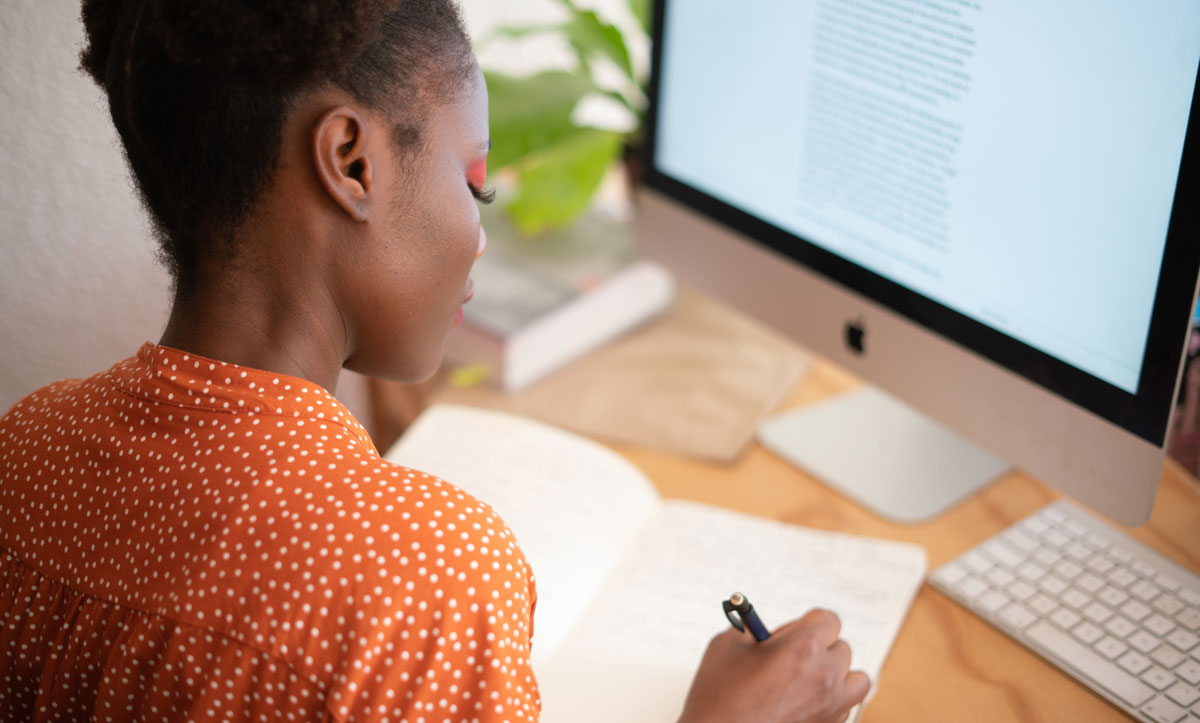 woman-writing-on-her-notebook-3059747